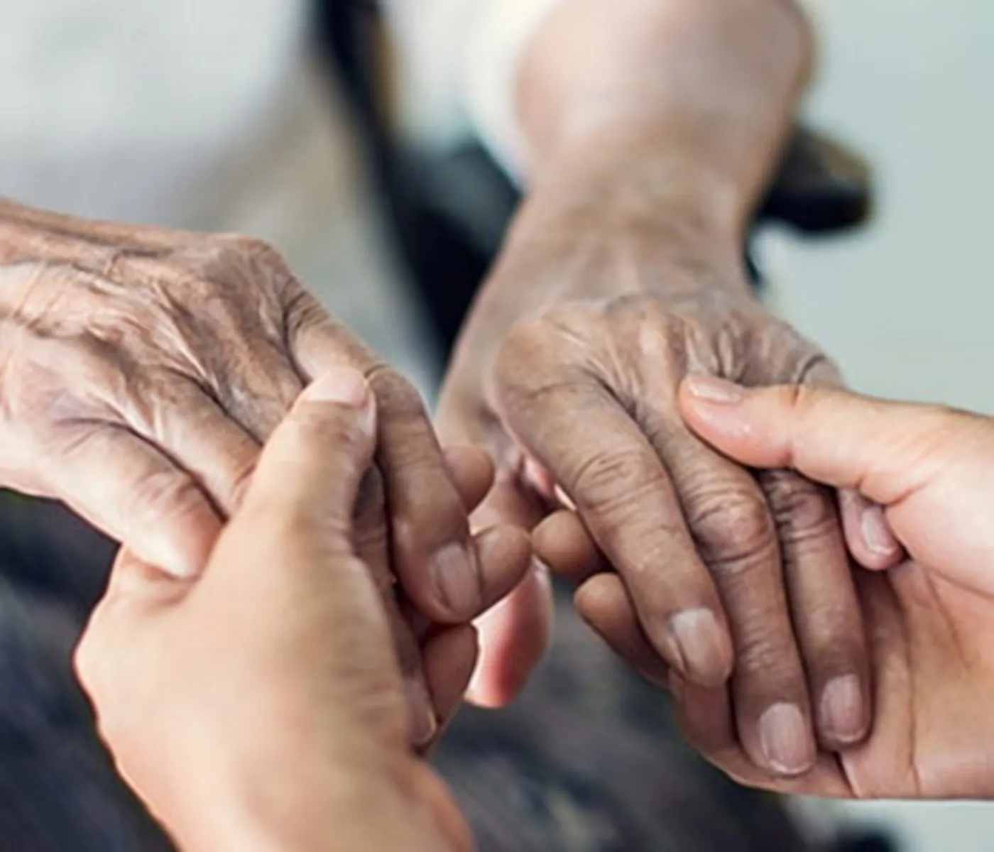Caregiver holding a senior’s hands