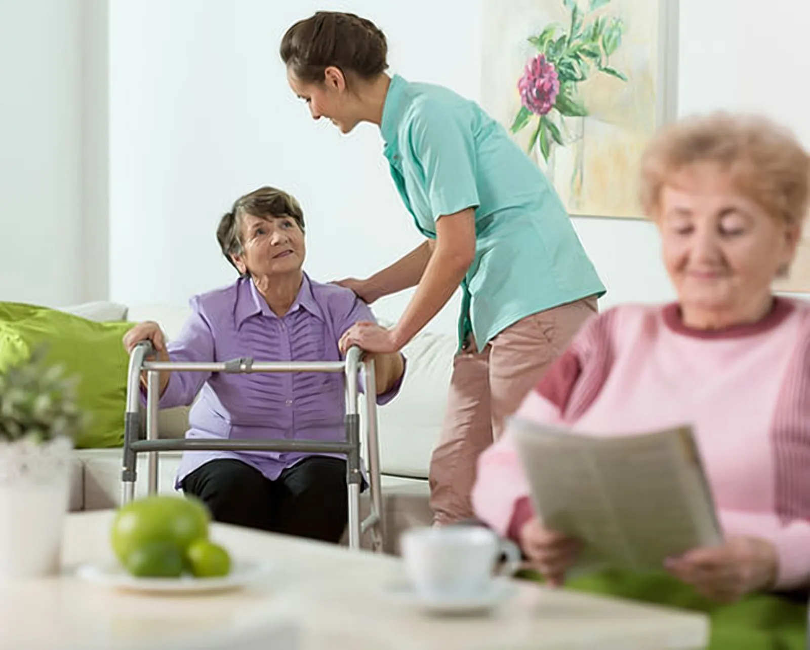 Caregiver helping a senior woman stand with her walker