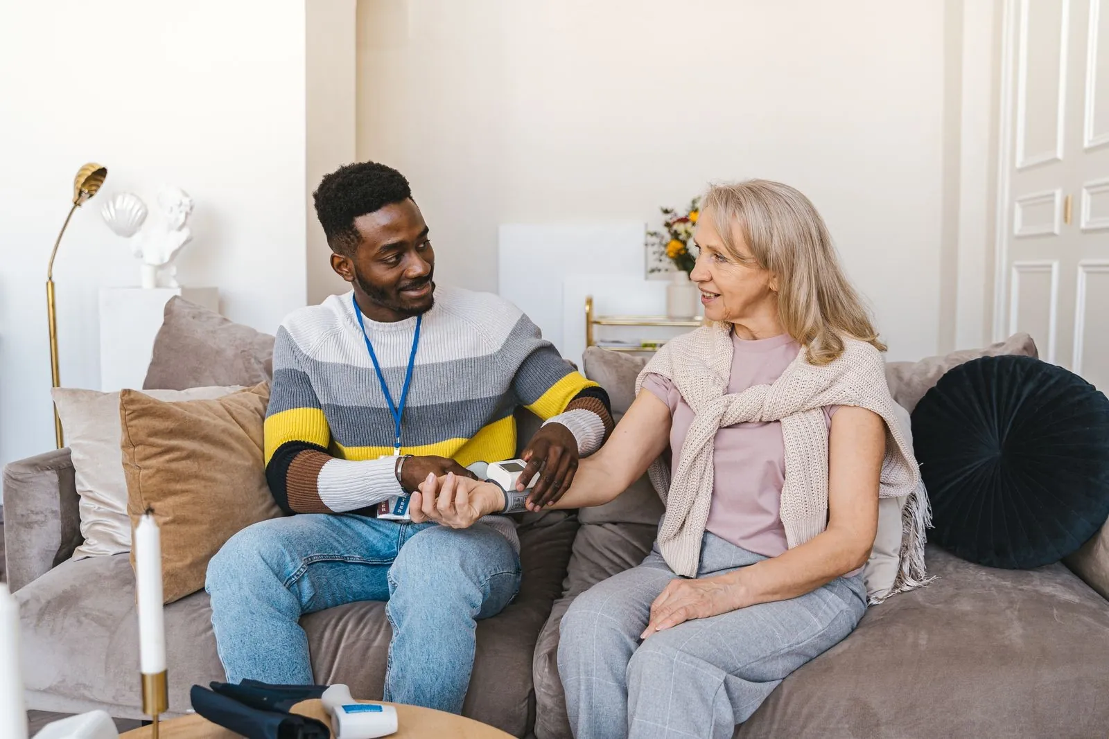 Caregiver and senior woman chatting during a home visit